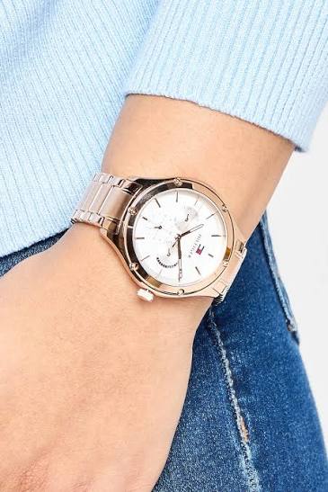 Tommy Hilfiger rose gold women's watch worn on wrist with silver-white dial