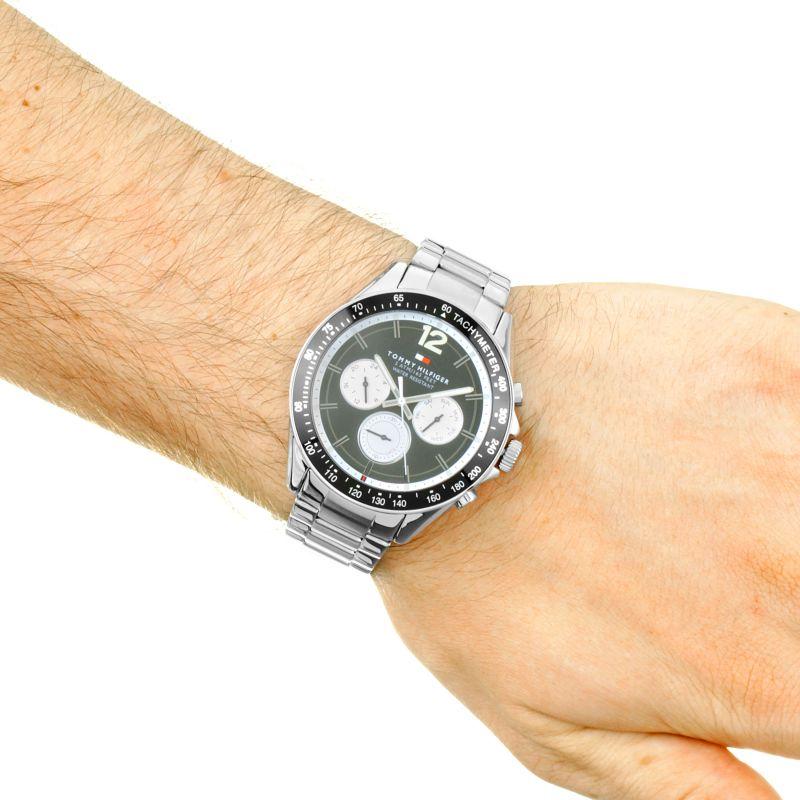 Tommy Hilfiger men's chronograph watch on wrist showing stainless steel bracelet and black dial