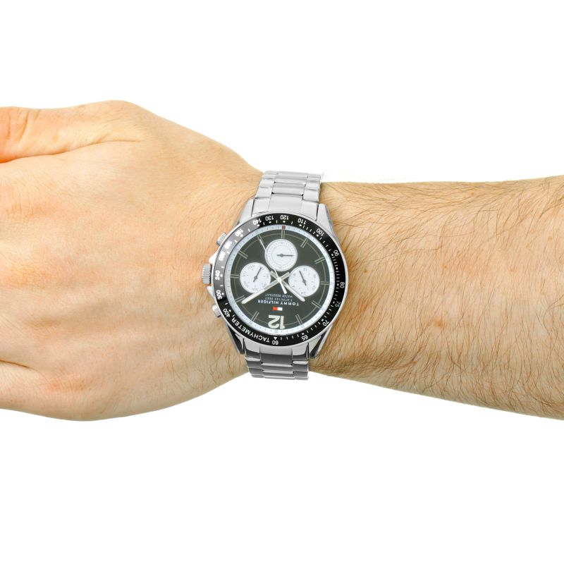 Tommy Hilfiger chronograph watch worn on wrist with black dial and tachymeter bezel