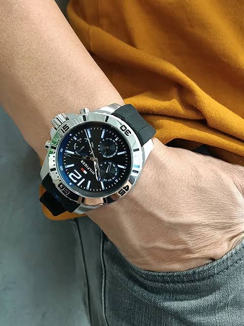 Tommy Hilfiger 1791143 chronograph watch worn on wrist with black rubber strap