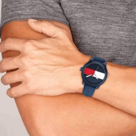 Tommy Hilfiger Flag Sport watch worn on wrist showing dial and blue silicone band