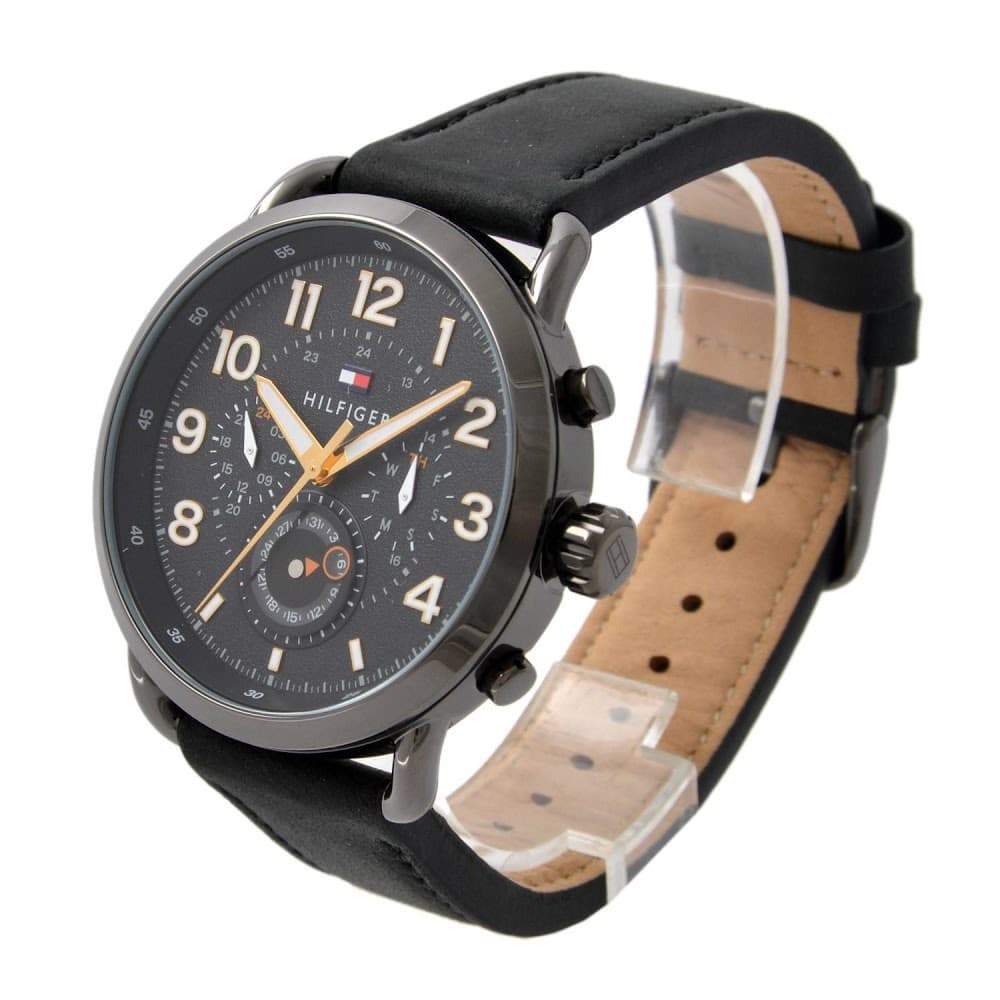 Side view of Tommy Hilfiger chronograph watch with black strap and tan suede lining detail