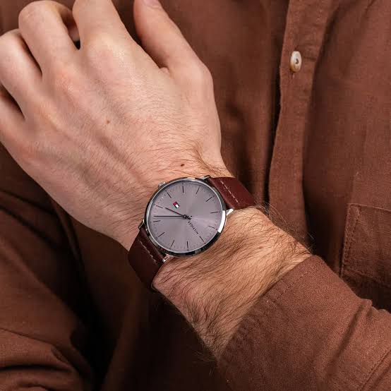 Tommy Hilfiger casual leather watch worn on wrist with brown leather strap