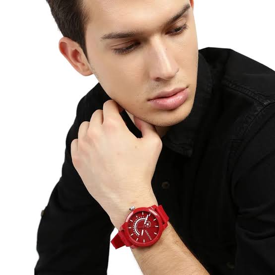 Tommy Hilfiger red watch worn on wrist, paired with black shirt