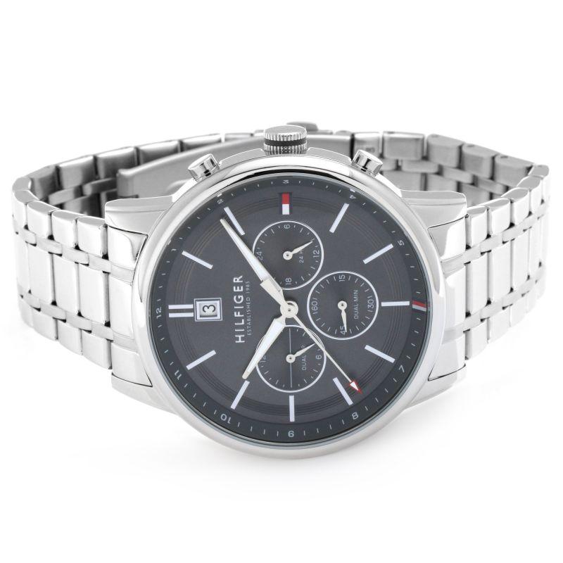 Tommy Hilfiger chronograph watch displayed on wrist showing grey dial and steel link bracelet