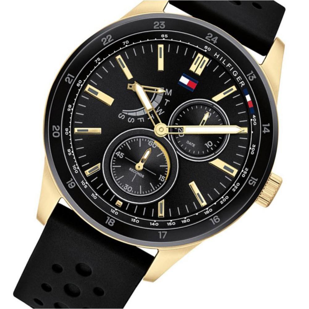 Tommy Hilfiger 1791636 multi-function watch at angle showing black silicone strap and gold-tone case