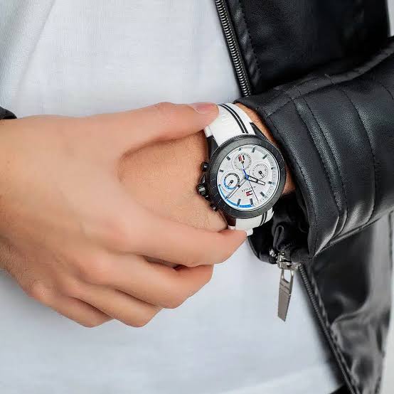 Tommy Hilfiger multifunction watch worn on wrist with black and white strap