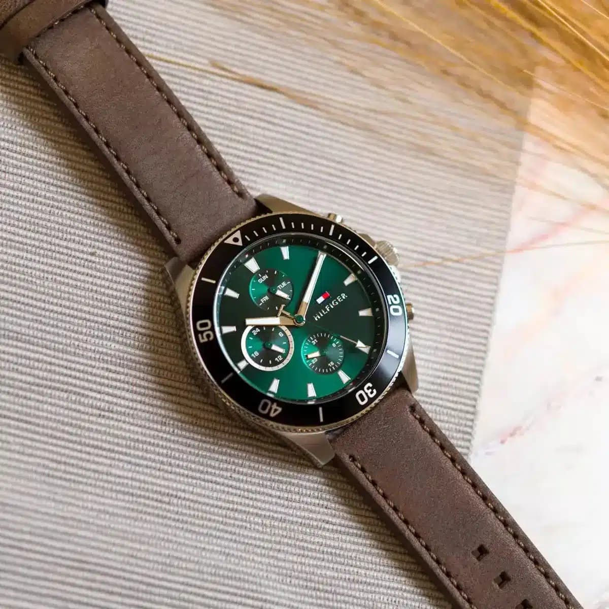 Tommy Hilfiger chronograph dial detail showing green face with white markers and subdials