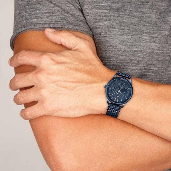 Tommy Hilfiger all-blue watch on wrist showing side profile and mesh strap