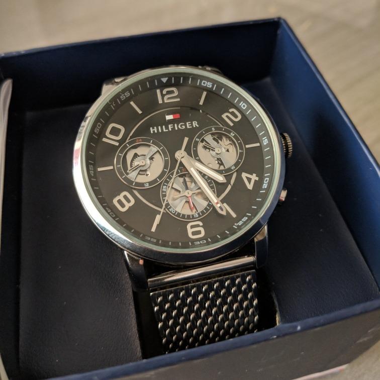 Tommy Hilfiger watch displayed in blue presentation box with instruction manual and warranty guide