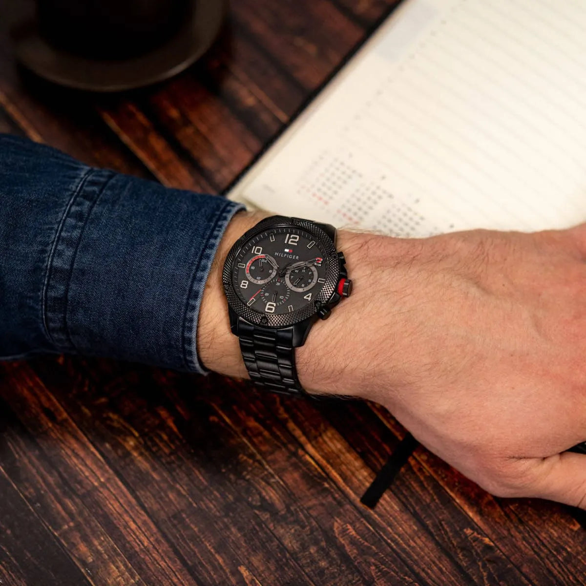 Tommy Hilfiger Blaze chronograph watch worn on wrist with black strap and dial