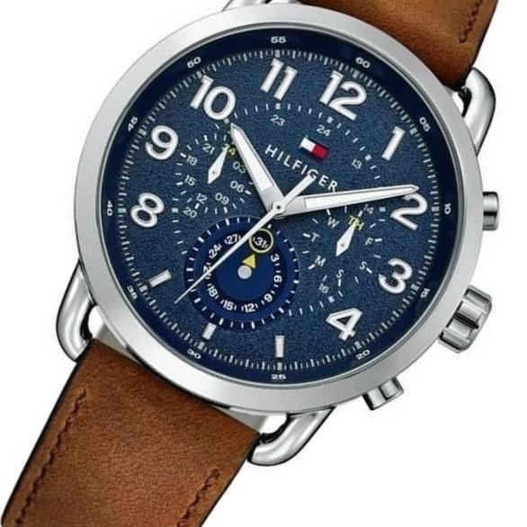 Close-up of navy dial showing chronograph subdials, moon phase, and applied numerals