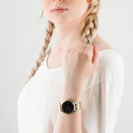 Tommy Hilfiger Brooke watch worn on wrist with black dial and gold steel case
