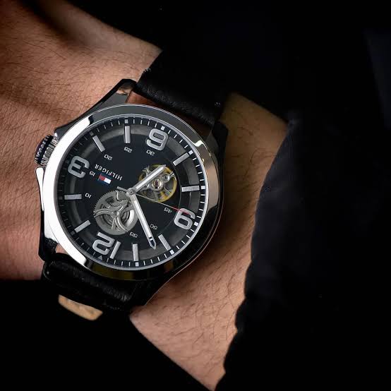 Tommy Hilfiger Bruce watch worn on wrist with black leather strap and visible skeleton dial