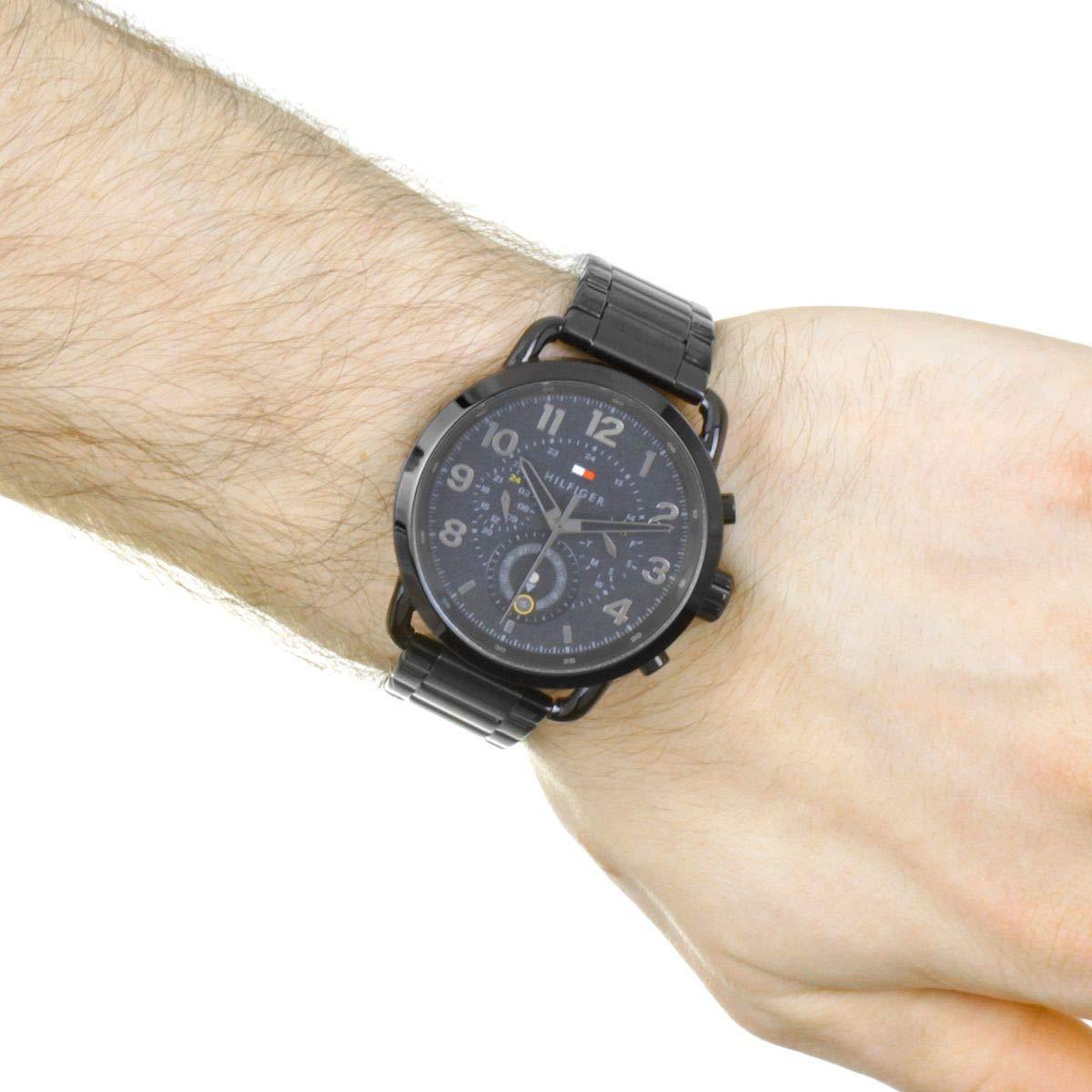 Tommy Hilfiger chronograph watch worn on wrist showing black case and dial