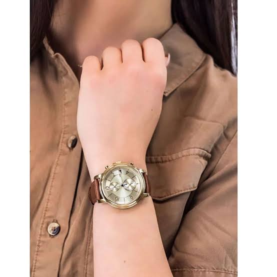 Tommy Hilfiger Claudia women's watch on wrist with gold case and brown leather strap