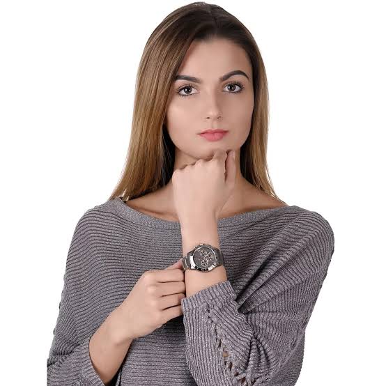 Tommy Hilfiger Haven chronograph watch worn on woman's wrist with grey dial and steel bracelet