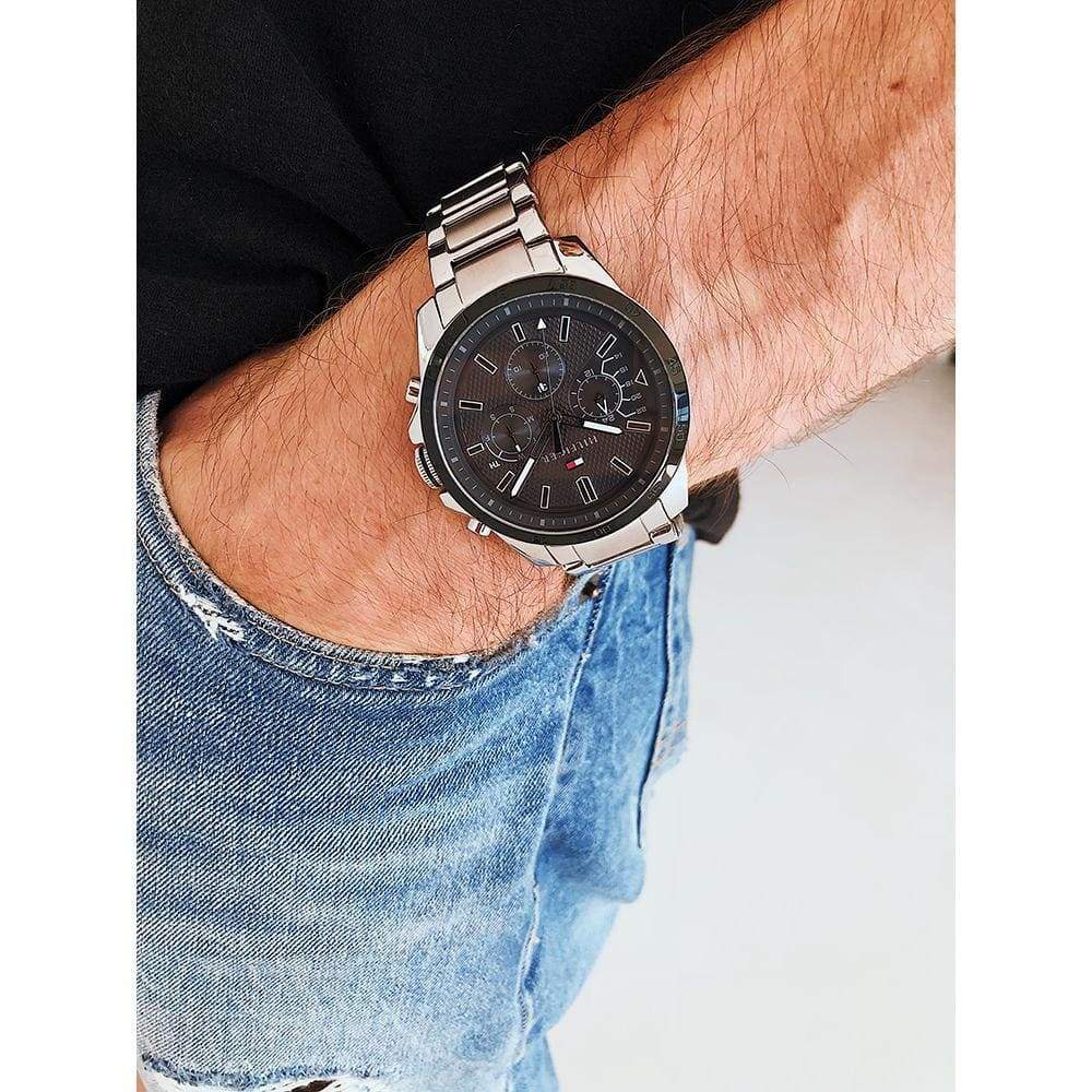 Tommy Hilfiger Iconic chronograph watch worn on men's wrist with black dial and steel bracelet