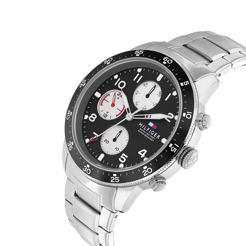 Tommy Hilfiger Jimmy chronograph watch at angle showing black bezel and steel bracelet links