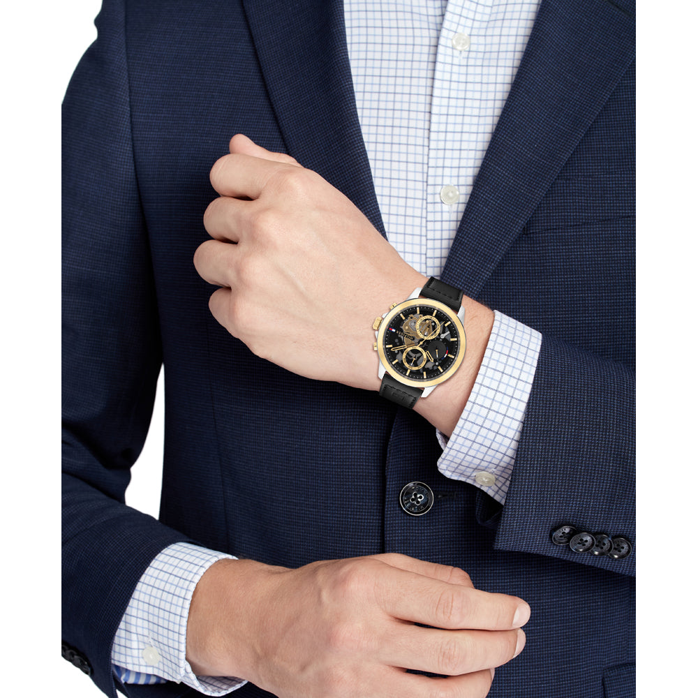 Tommy Hilfiger chronograph watch worn on wrist with formal business attire