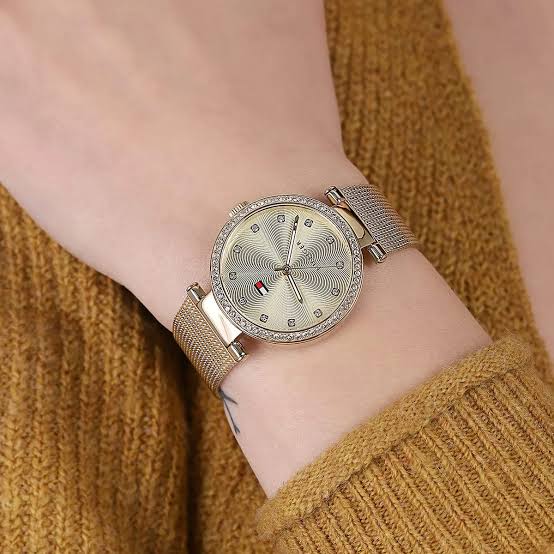 Tommy Hilfiger Lynn watch on wrist with gold mesh band and crystal-set bezel