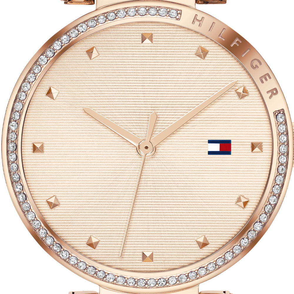 Dial detail showing crystal accents, Tommy Hilfiger logo, and rose gold indexes