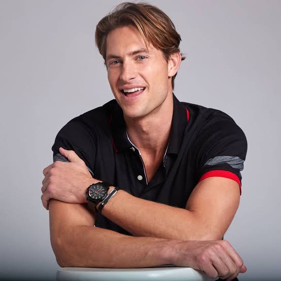 Man wearing Tommy Hilfiger Mason black chronograph watch on wrist