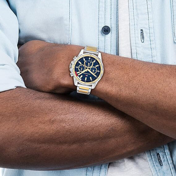 Tommy Hilfiger Mason chronograph watch worn on wrist with blue dial and two-tone bracelet