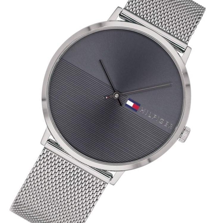 Angled view of Tommy Hilfiger men's watch showcasing silver mesh band and dark dial face