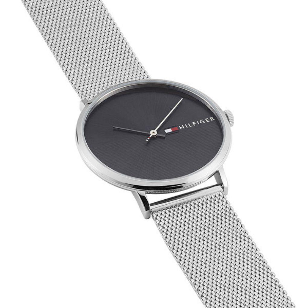Tommy Hilfiger men's watch on wrist with silver mesh band and dark dial