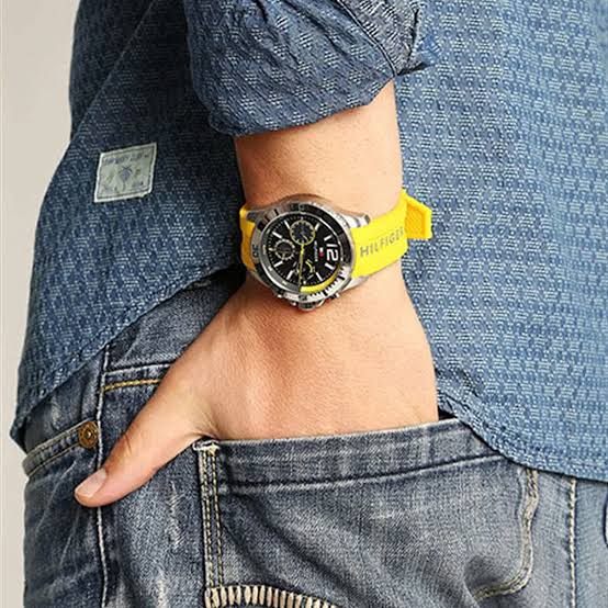 Tommy Hilfiger Shawn chronograph watch worn on wrist with yellow strap against blue denim
