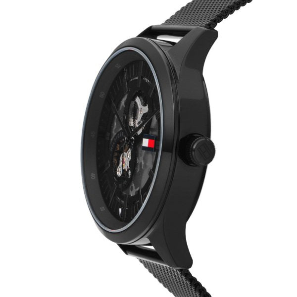 Side profile of Tommy Hilfiger Spencer skeleton watch showing case depth and mesh bracelet