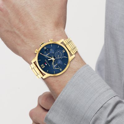 Tommy Hilfiger Sullivan gold chronograph watch worn on wrist with navy dial