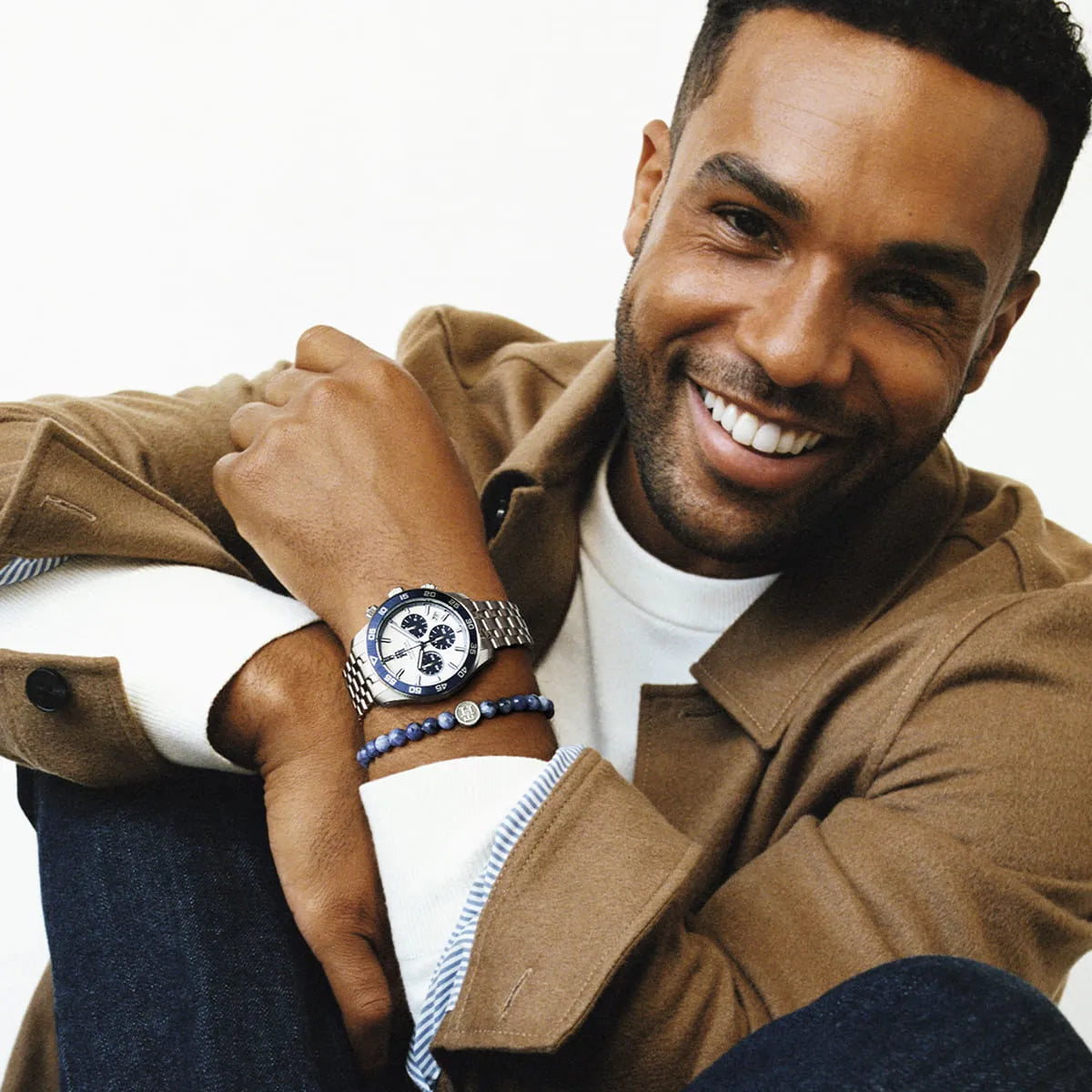 Man wearing Tommy Hilfiger TH85 chronograph with blue beaded bracelet