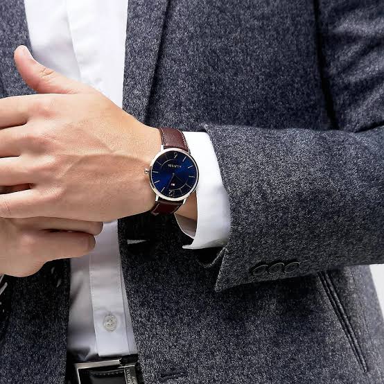 Tommy Hilfiger Ultra Slim watch worn on wrist with blue dial and brown leather strap