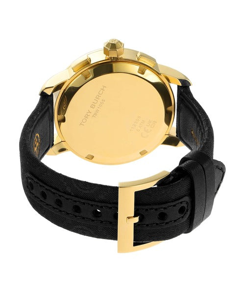 Watch caseback close-up revealing gold-tone case interior and Tory Burch engraving