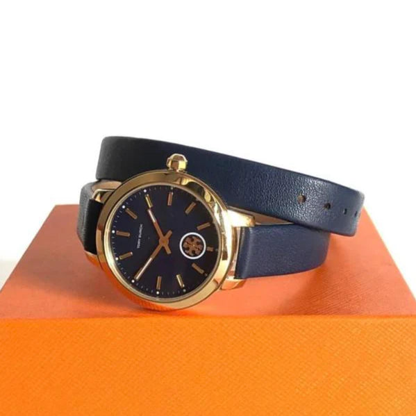 Tory Burch Collins watch on wrist with blue leather strap on orange box