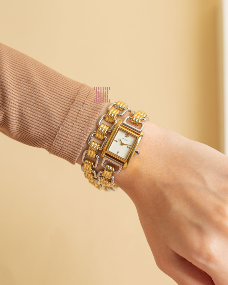 Eleanor watch styled on wrist with cream-toned clothing, showing two-tone bracelet and case