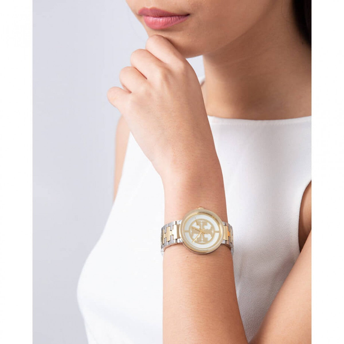 Tory Burch The Reva watch worn on wrist with dual-tone gold and silver bracelet