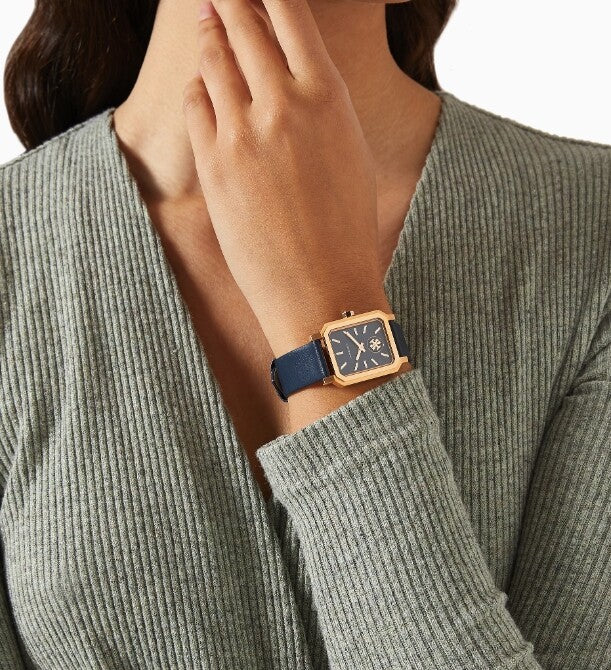 Robinson octagonal watch on wrist with navy leather strap and rose gold case