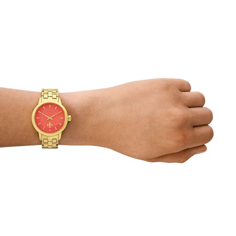 Tory Burch TBW1056 women's watch on wrist with red dial and gold bracelet