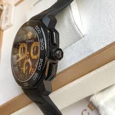 Versace Dylos black chronograph watch on wrist showing gold subdials and case detail