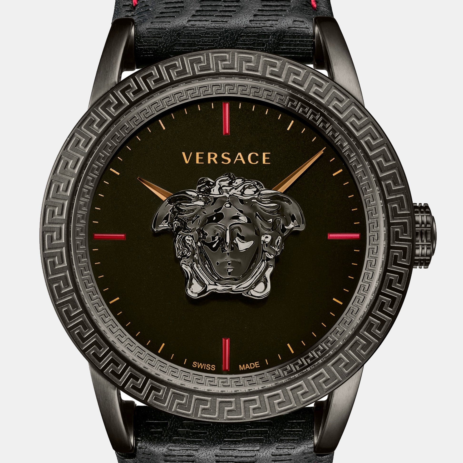 Close-up of black dial featuring Versace Medusa head logo and red hour markers