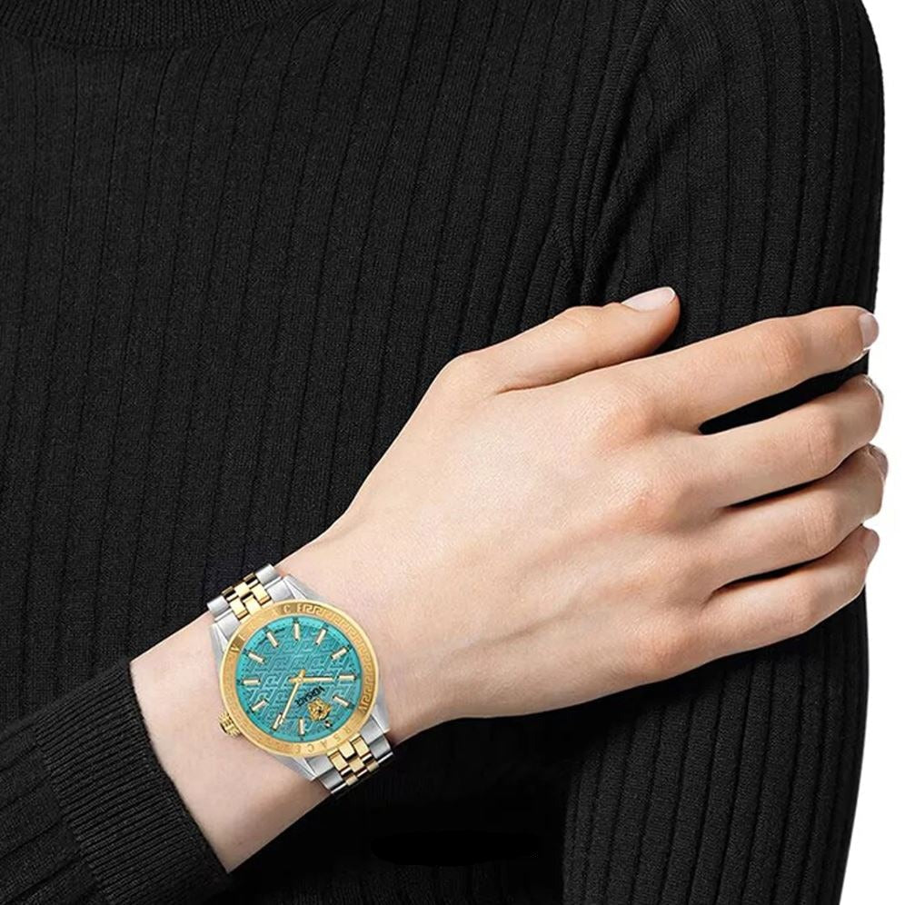 Versace V Code blue dial watch worn on wrist with two-tone metal bracelet