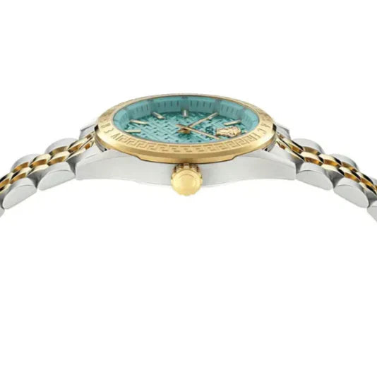 Top-down angled view of V Code watch dial with gold bezel and steel bracelet