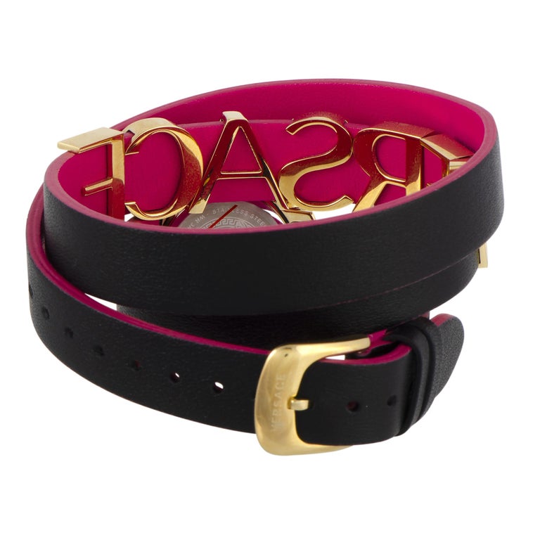 Versace V-Flare bracelet-style wrap strap coiled showing black-magenta leather with gold-tone Versace branding
