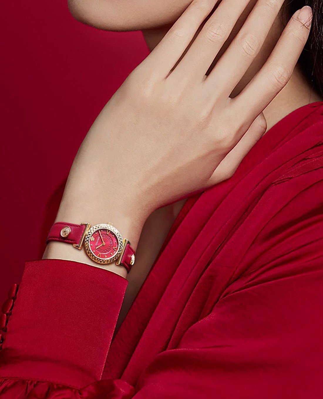 Versace V-Motif red dial watch on wrist with red leather strap
