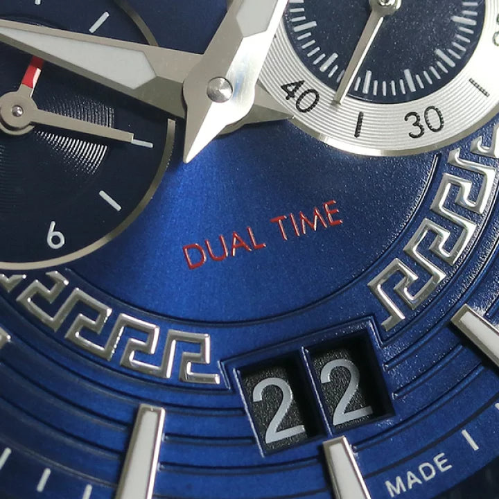 Close-up of Versace V-Race dial showing dual time feature, date window, and Greek key design details