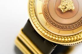 Close-up of dial detail showing Medusa head center and decorative Greek key pattern bezel