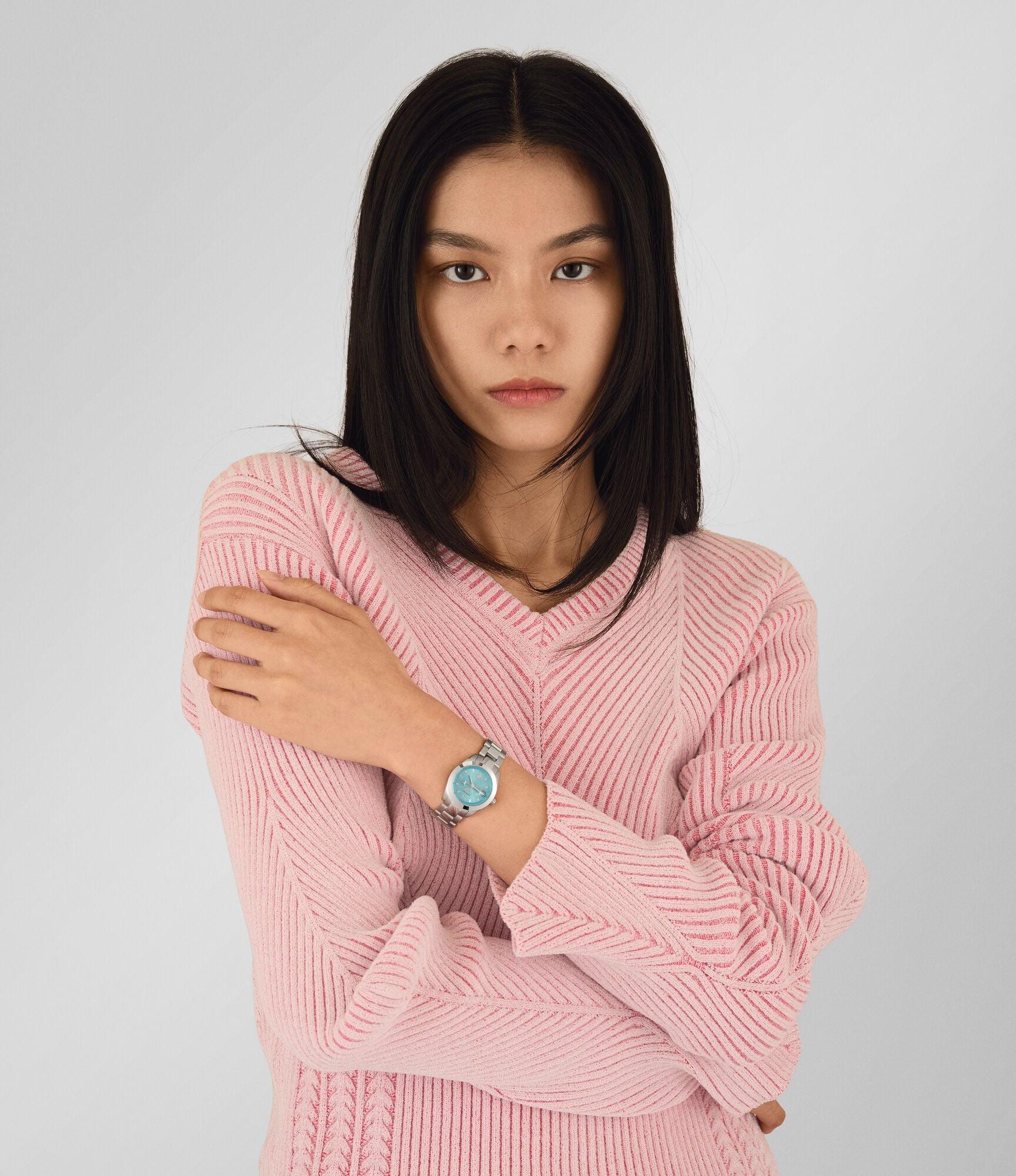 Vivienne Westwood Fenchurch ladies watch worn on wrist with turquoise dial and silver bracelet